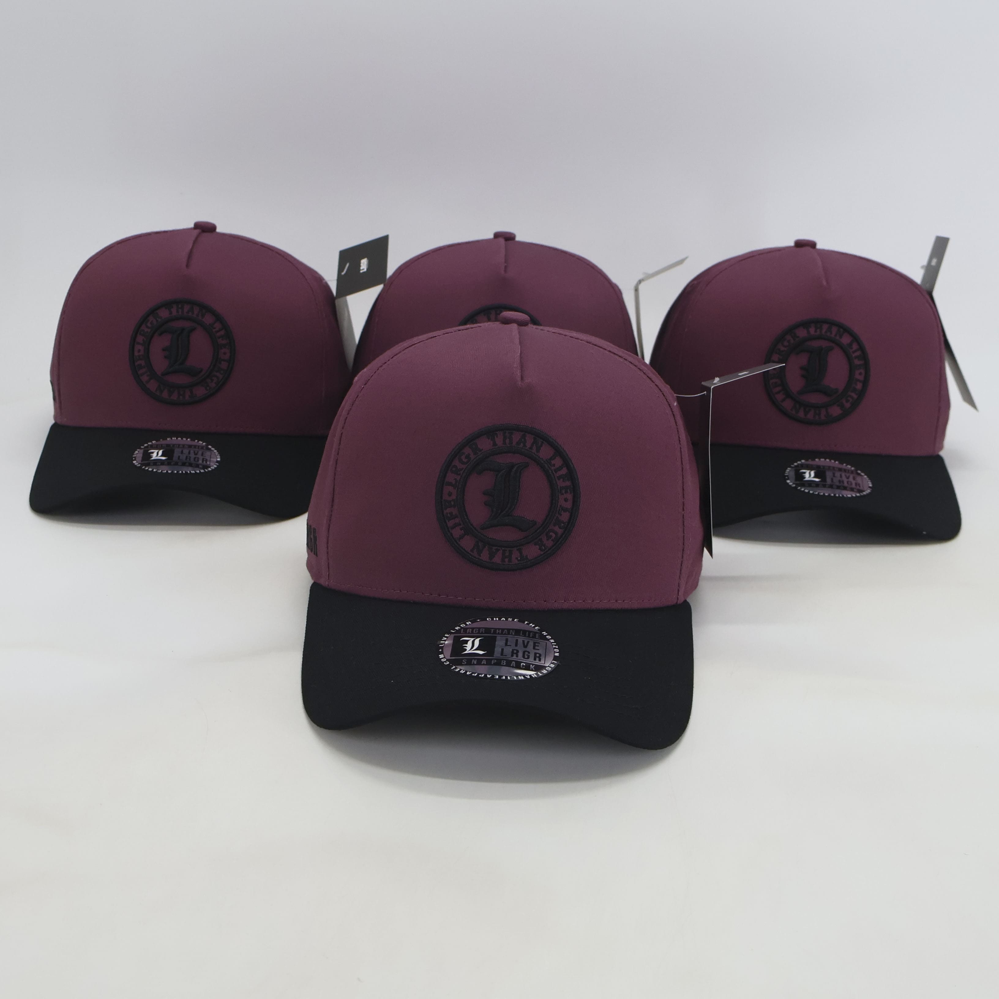 Four maroon and black caps with a logo on a white background