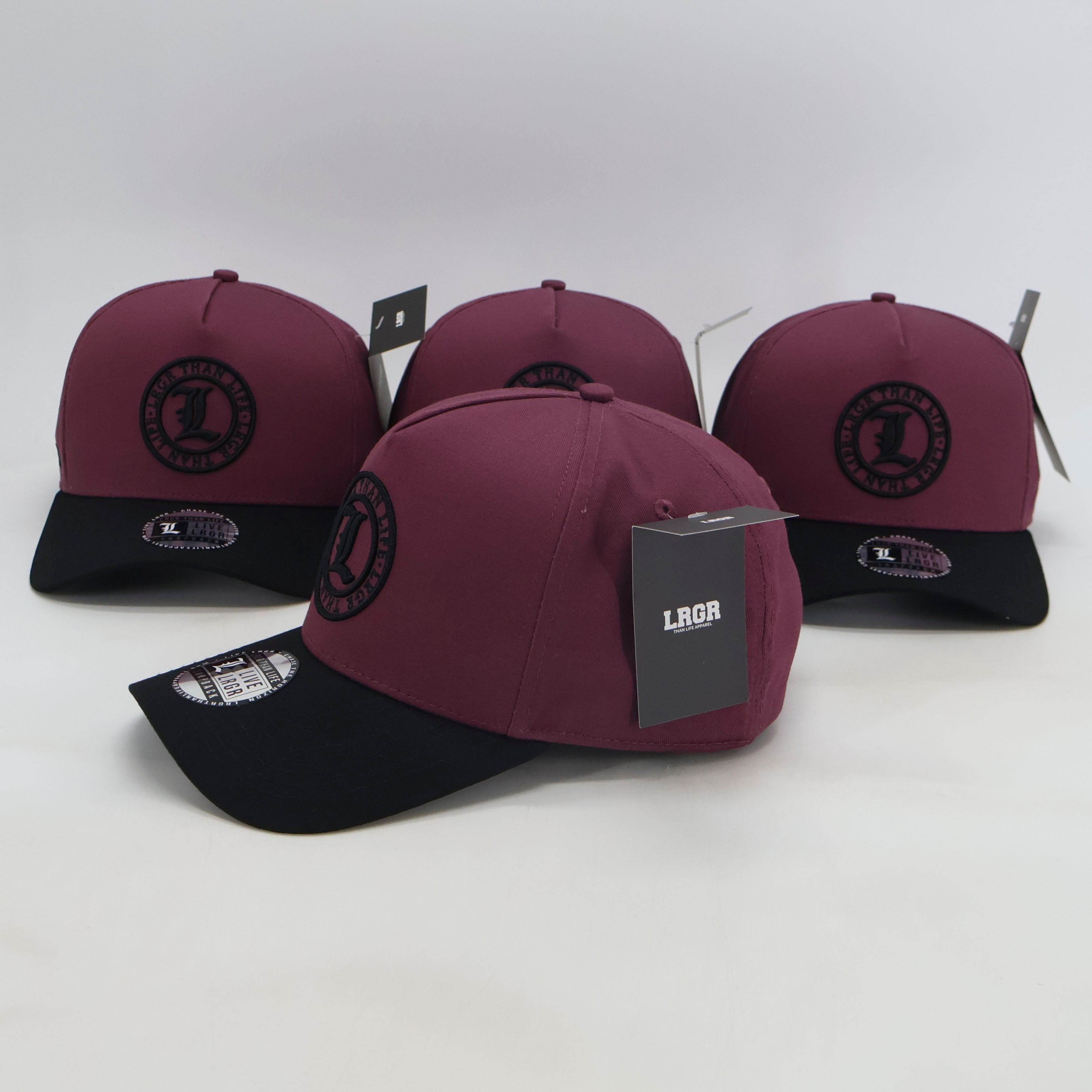 Three maroon and black baseball caps with a visible brand logo on a white background