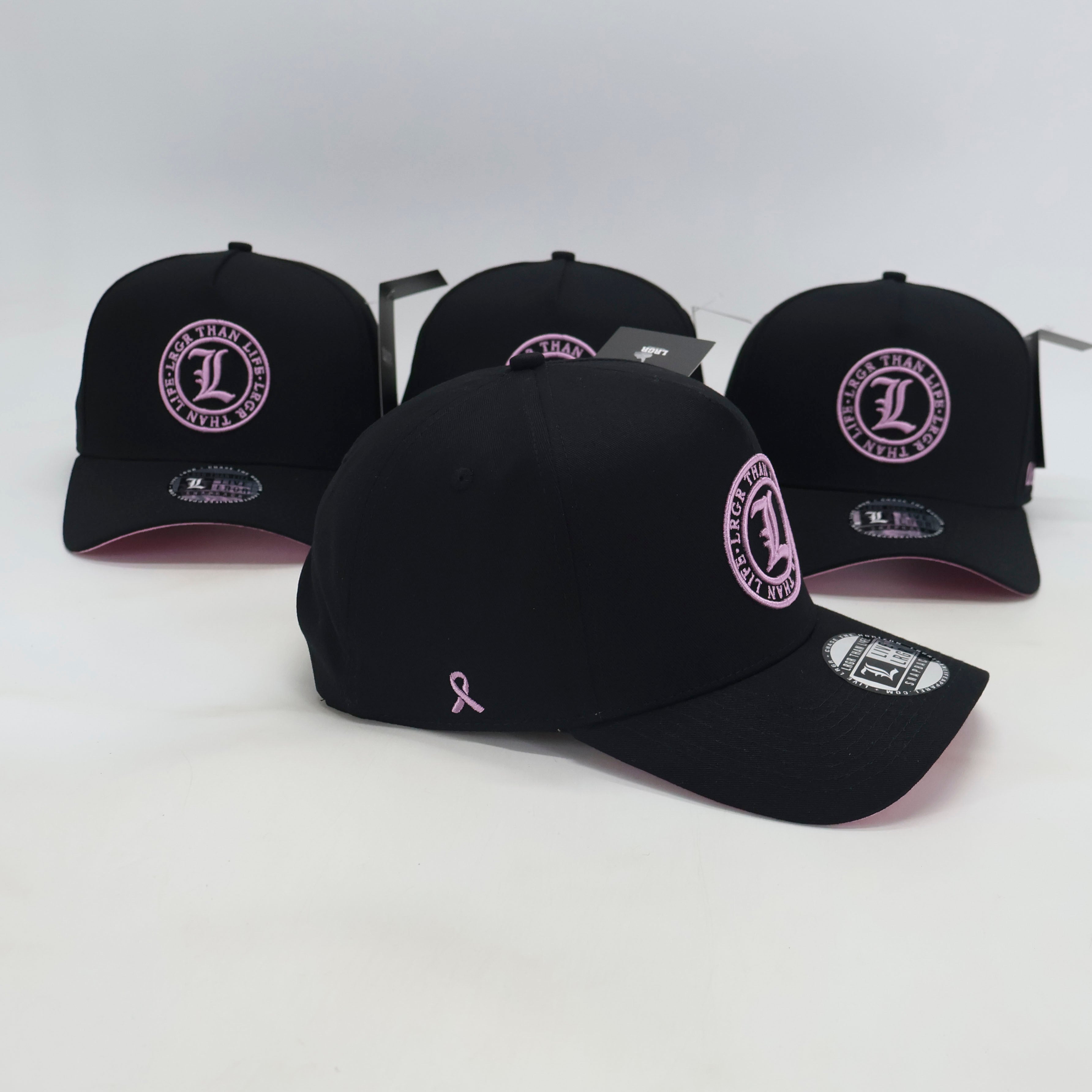Black baseball caps with pink logos on a white background
