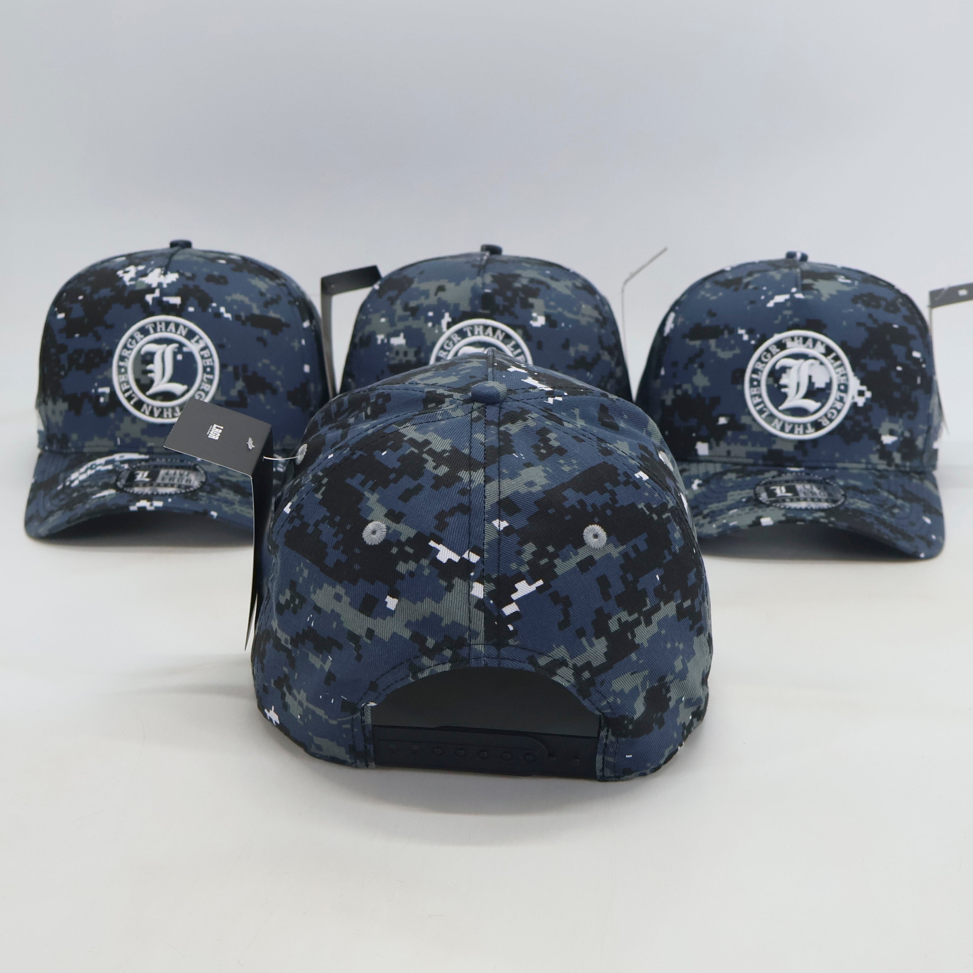 Four blue camouflage baseball caps with a logo on a white background