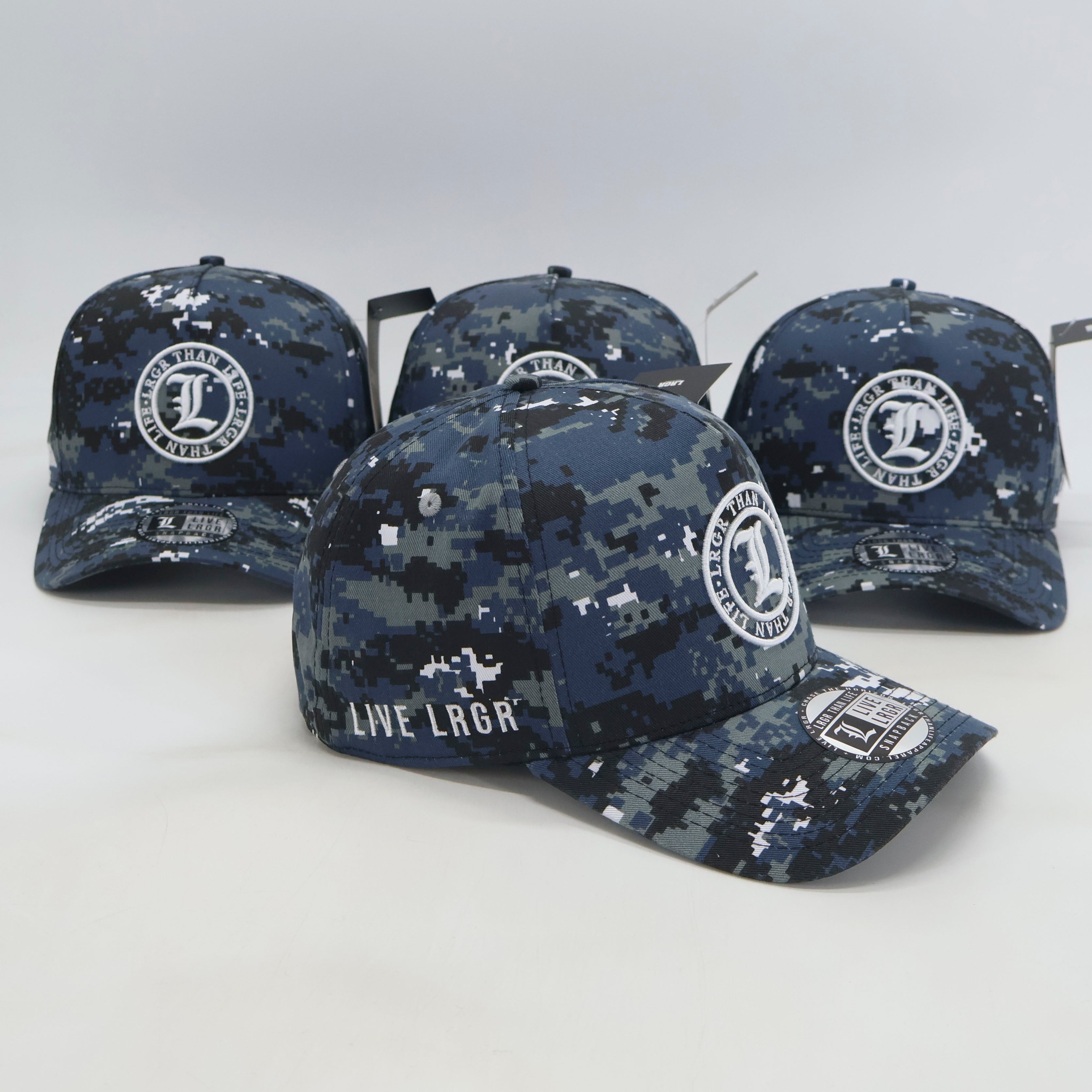 Four camouflage baseball caps with visible branding on a light gray background