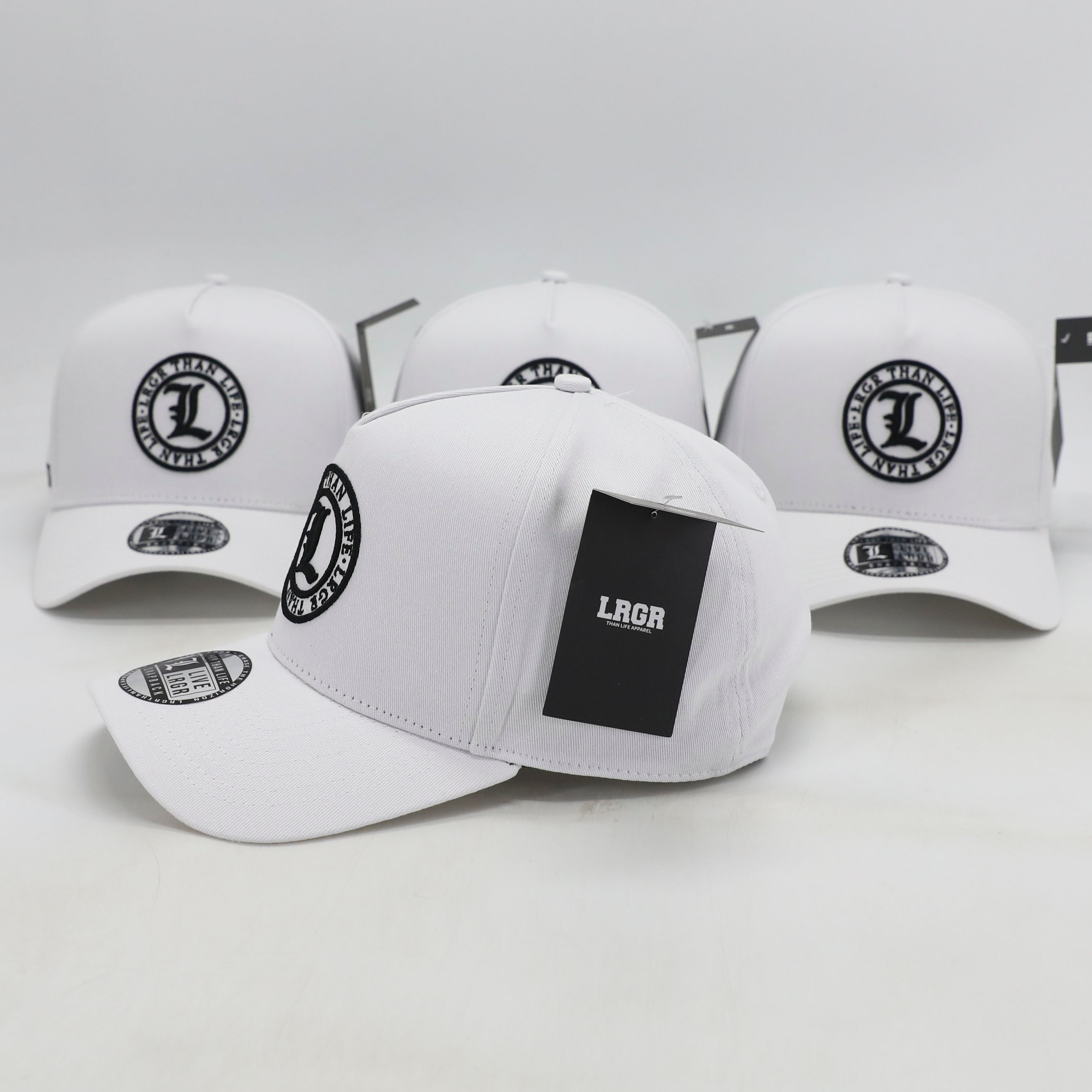 White baseball caps with black logos on a light gray background