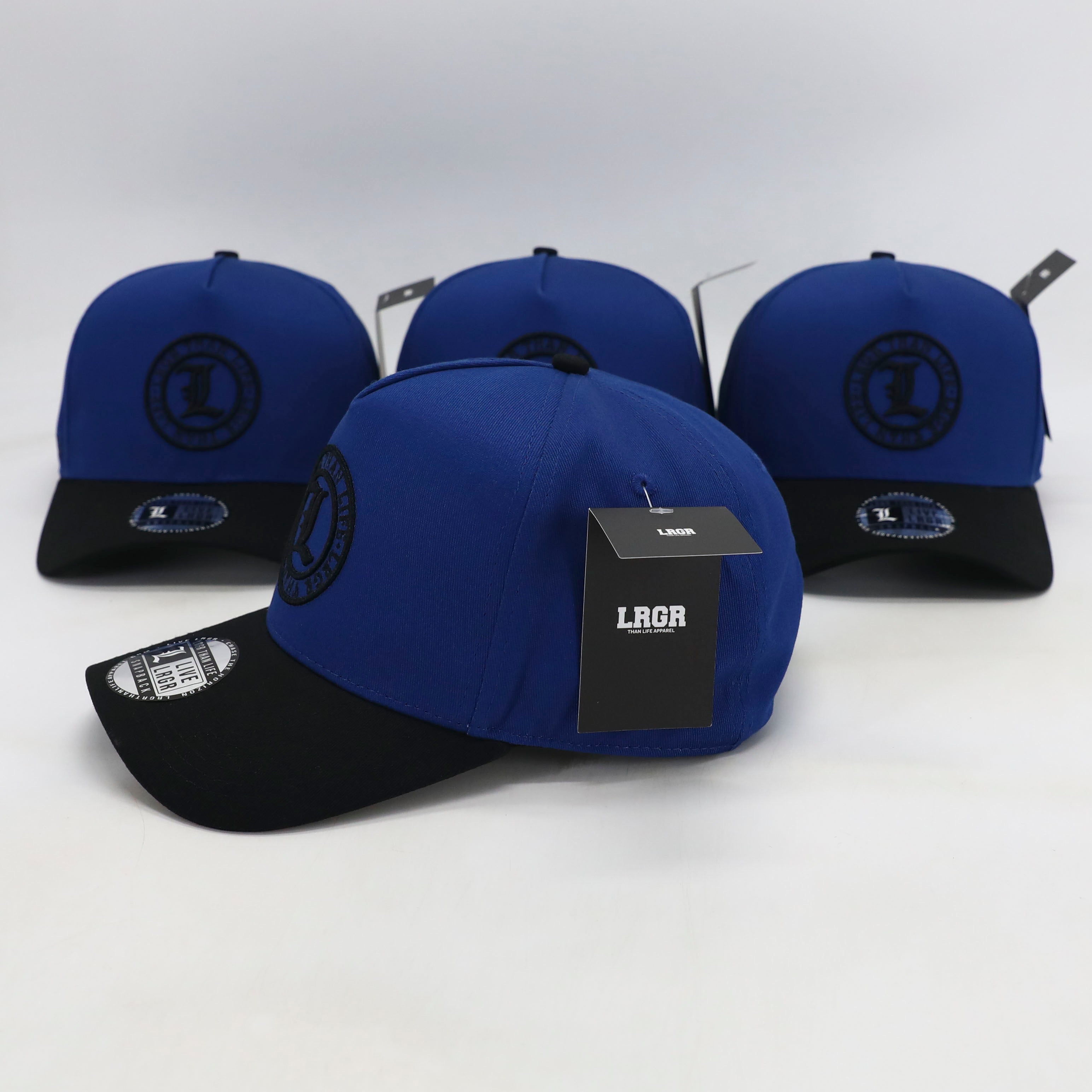 Blue and black baseball caps with visible branding on a white background