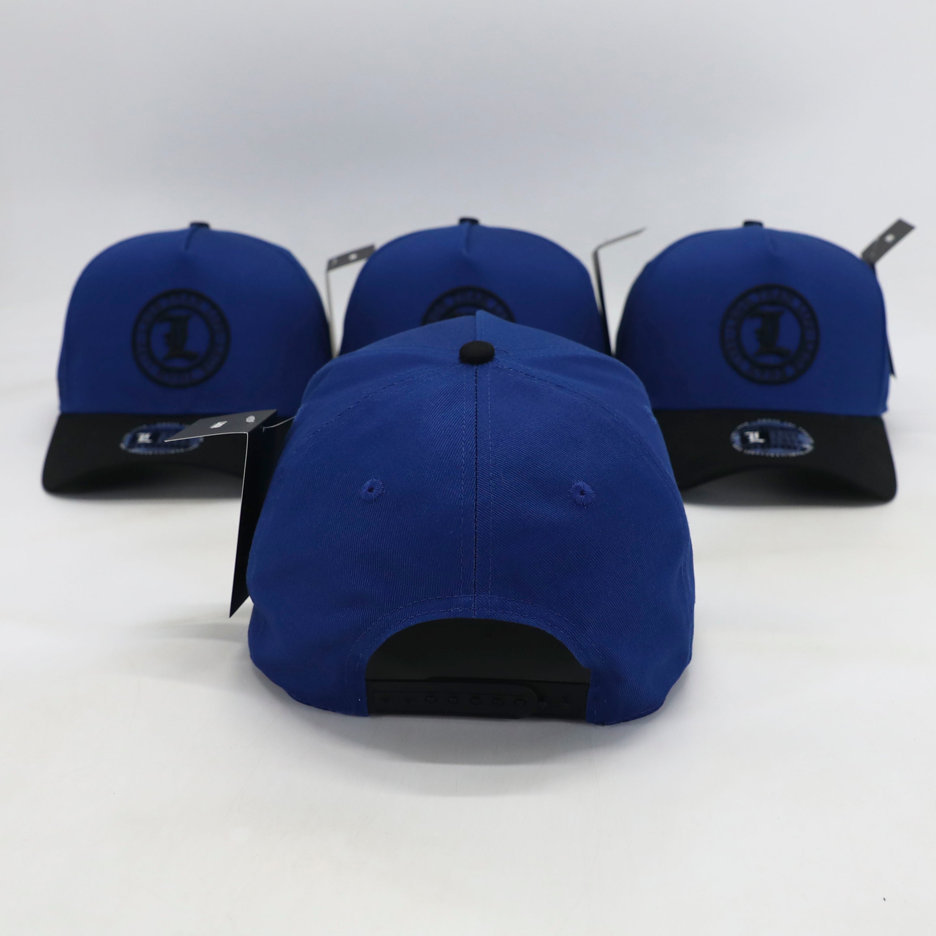 Blue baseball caps with black logos on a white background