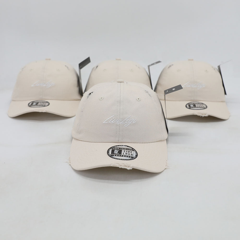 A collection of beige dad hats with a brand tag on the brim.