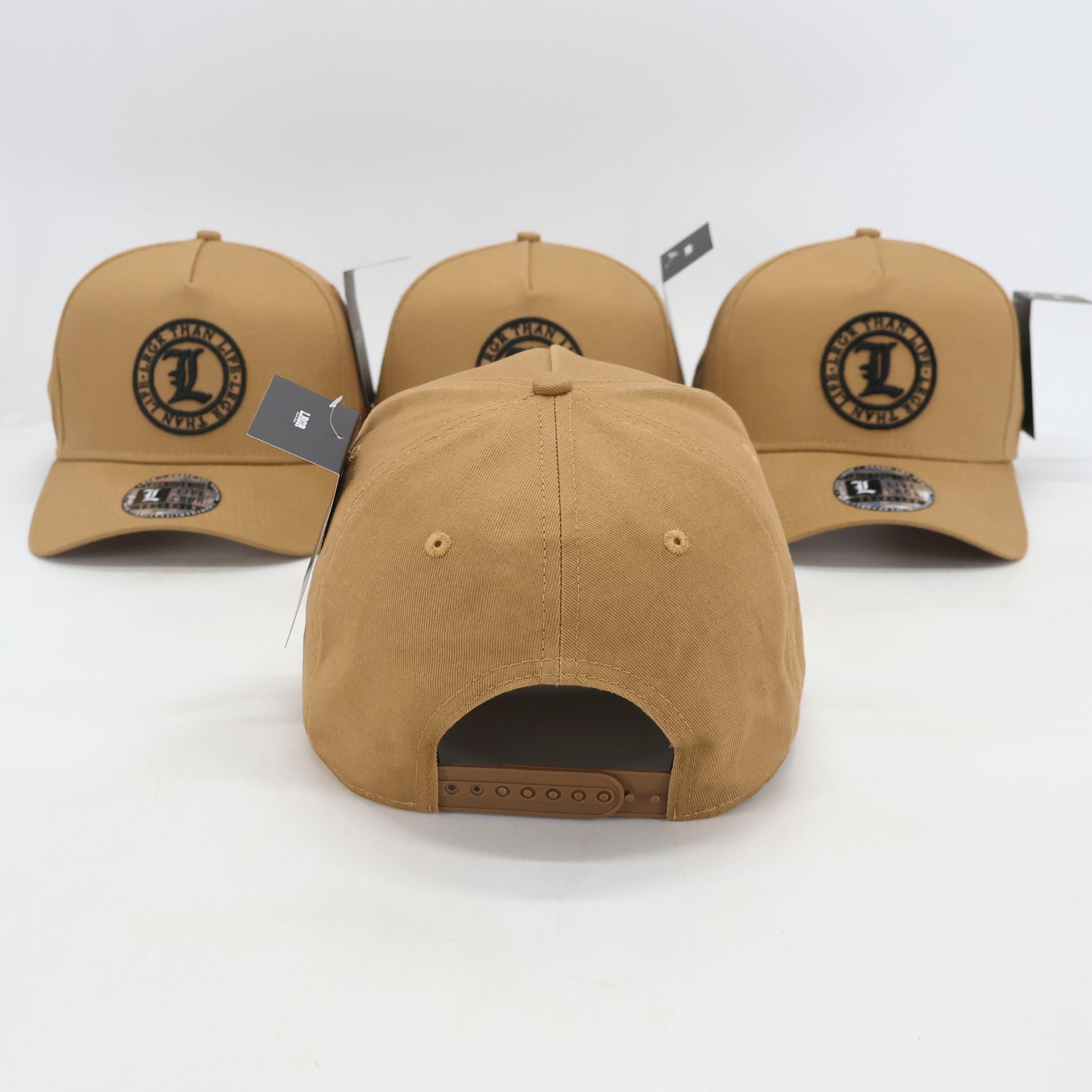 Four tan baseball caps with a logo on a white background